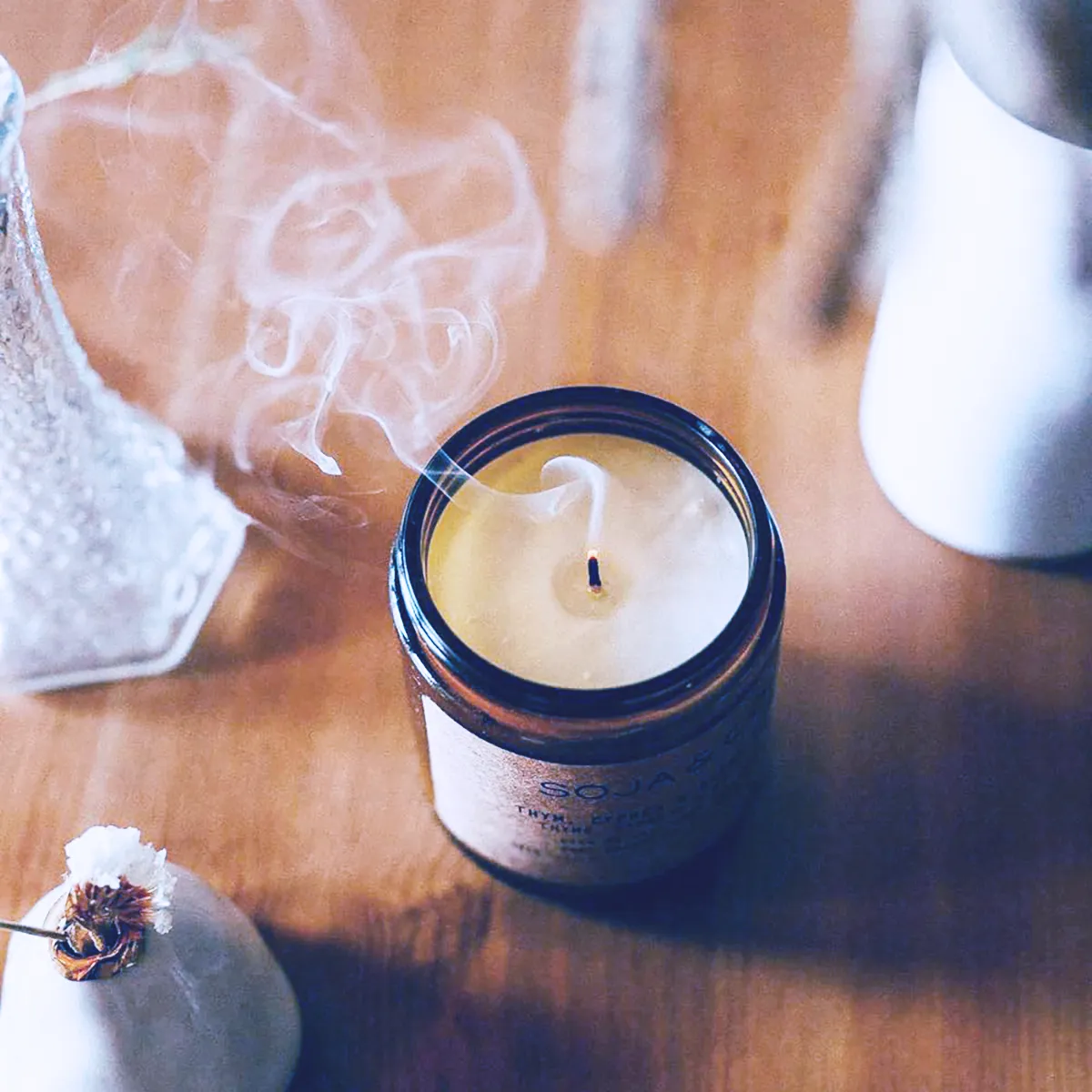 A SOJA & CO. candle emitting a soft, tranquil smoke, ideal for relaxation.