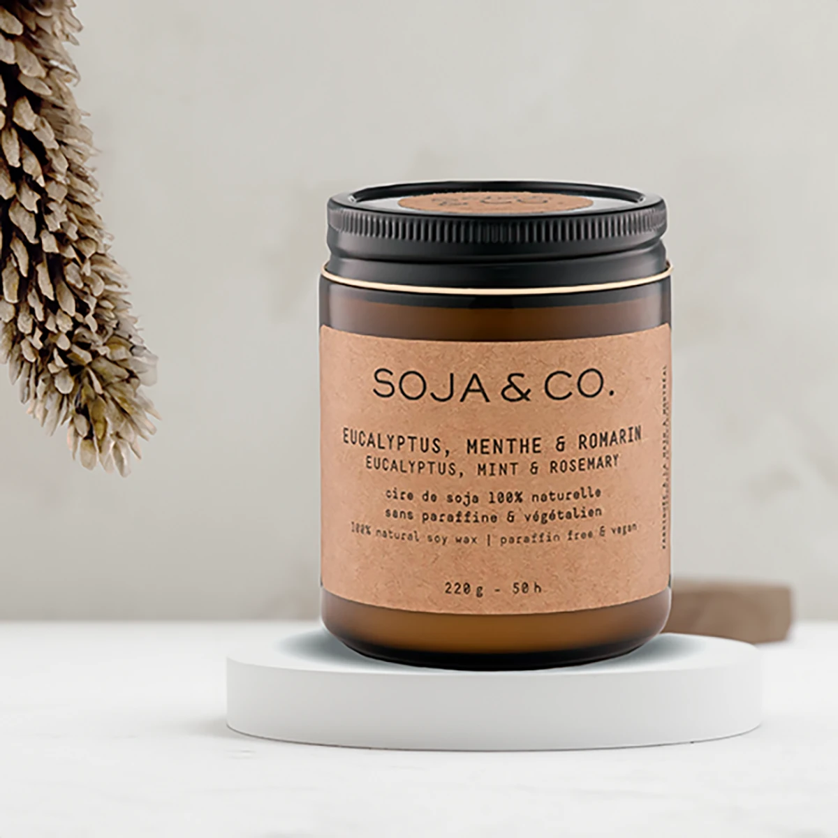 SOJA & CO. natural soy candle with eucalyptus, mint, and rosemary scents in a brown glass jar.