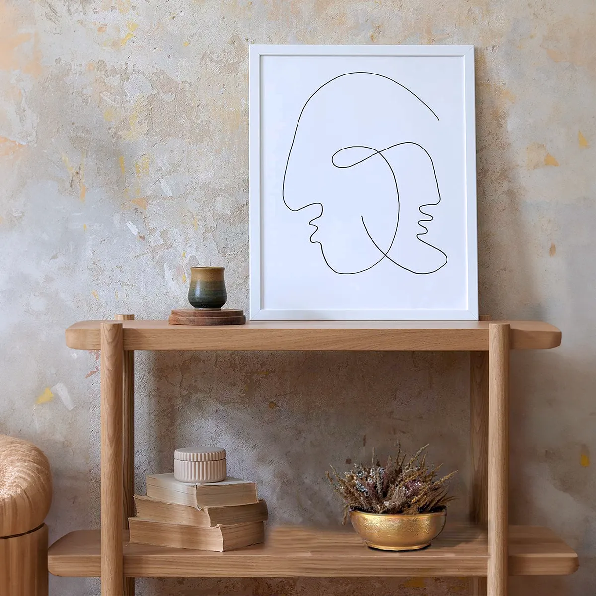 Antique brass decorative bowl on a modern wooden shelf against a textured wall, adding a touch of rustic elegance to home decor.