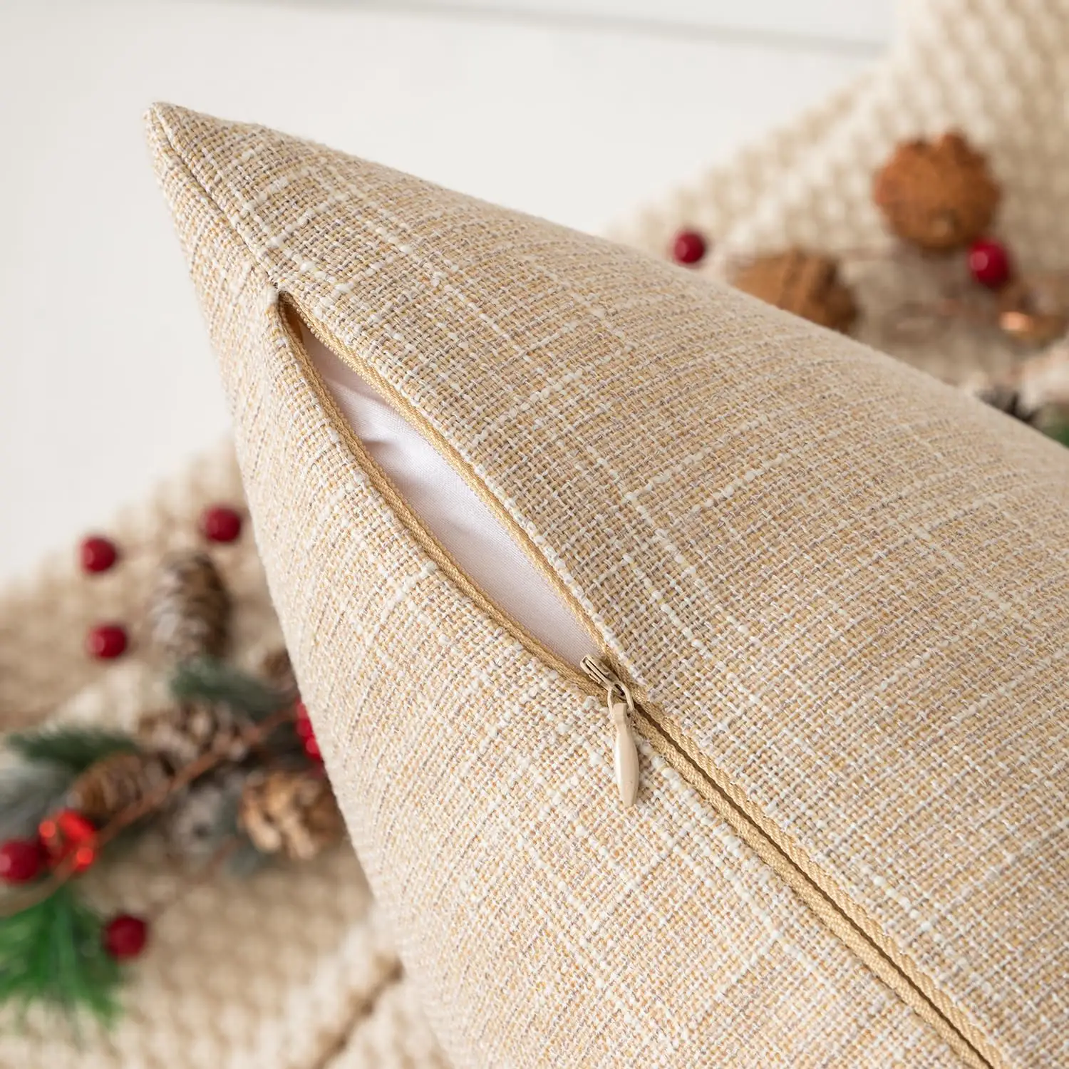 Close-up of the hidden zipper on a natural linen cushion cover, exemplifying the cover's elegant and enduring design.